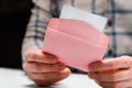 A man holds a pink envelope and reads a love letter Royalty Free Stock Photo