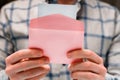 A man holds a pink envelope and reads a love letter Royalty Free Stock Photo