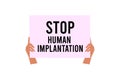 A man holds a placard with the inscription. Stop human implantation. A protest against the microchipping of people Royalty Free Stock Photo