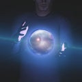 Man holds planet and space in sphere