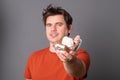 Man holds a plate of chocolate ice cream. Funny man with an appetite eats ice cream