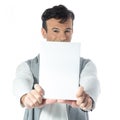 Man holds plate in front of face. Brazilian male wearing neutral