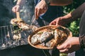 A man holds a plate with a ready meal. delicious and fresh grilled fish with lemon on the Barbeque grill at the garden Royalty Free Stock Photo