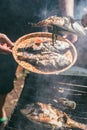 A man holds a plate with a ready meal. delicious and fresh grilled fish with lemon on the Barbeque grill at the garden Royalty Free Stock Photo