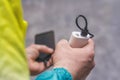 Man holds a power bank in his hands and charges a smartphone against a concrete wall Royalty Free Stock Photo