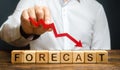 Man holds red arrow down over word Forecast. A budget shortage, recession economy, unprofitable company. Prediction of profit fall Royalty Free Stock Photo