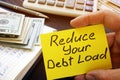 Man holds Reduce your debt load sign