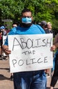 A Man Holds a Sign Reading `Abolish The Police`