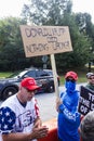 Man holds sign saying Trump did nothing wrong outside Atlanta jail