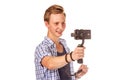 Man holds small action camera on gimbal.