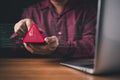 A man holds a smartphone displaying a red warning alert symbol, representing cybersecurity threats, data breaches, hacking, or Royalty Free Stock Photo