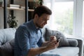 Man holds smartphone feels disillusioned losing online lottery Royalty Free Stock Photo