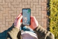 Man holds a smartphone with online maps application. Close-up, top view. The concept of Internet applications for