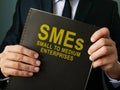 Businessman holds SMEs Small to Medium Enterprises