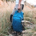 Man holds sport blue backpack