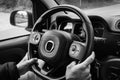 Man holds the steering wheel firmly with both hands. Hands on steering wheel of car driving on highway Royalty Free Stock Photo