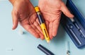 A man holds a syringe for subcutaneous injection of hormonal drugs in the IVF Royalty Free Stock Photo