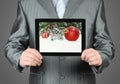 Man holds tablet PC with Christmas composition