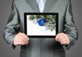 Man holds tablet PC with Christmas composition