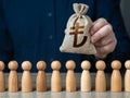 A man holds a turkish lira money bag above the crowd. Deposits and loans. Royalty Free Stock Photo