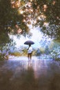 The man holds umbrella standing on the wet road