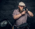 A man holds vintage camera.