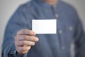 A man holds a white business card. A paper in the hands of a man. Prepared for your text. Isolated on a gray background Royalty Free Stock Photo