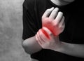 Man holds he wrist hand injury, feeling pain. Health care and medical conept Royalty Free Stock Photo