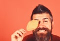 Man holds yellow cherry tree leaves on peachy orange background