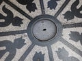 Man hole cover with tulip formed decorations in granito Royalty Free Stock Photo