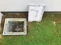 A man hole water and a hole of grease trap with the drain system around the house. Royalty Free Stock Photo