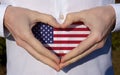 man holidng his hands in heart shaped on white shirt with usa flag colors national holiday concept Royalty Free Stock Photo