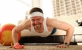 Man at home doing pushups on carpet and sofa