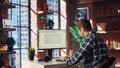 Man at home looking at UI on PC screen, typing and executing programming code Royalty Free Stock Photo