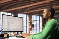 Man in home office looking at PC screen, executing programming code Royalty Free Stock Photo