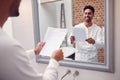 Man At Home Practising Giving Speech Or Presentation In Bathroom Mirror