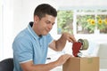 Man At Home Sealing Box For Dispatch Royalty Free Stock Photo