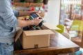 Man at home unpacking parcel with clothing