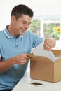 Man At Home Unwrapping Digital Tablet Bought Online