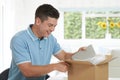 Man At Home Unwrapping Digital Tablet Bought Online Royalty Free Stock Photo