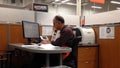 Man of Homedepot worker typing information on computer