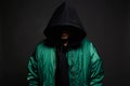 Man in Hood and green bomber jacket. Trendy wear Boy in a hooded sweatshirt Royalty Free Stock Photo