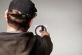 Man in hooded shirt and hat aiming with knife at the target