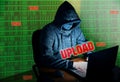 Man in hoodie is hacking personal data on green background. Information security. Upload process concept. Information protection.