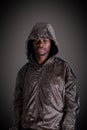 Man in hoodie looking at camera on black background Royalty Free Stock Photo