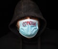 Man in hoodie with mask to protect him from Coronavirus. Corona virus pandemic. Corona health care. Young man with medical mask