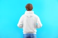 Man in hoodie sweater on color background Royalty Free Stock Photo