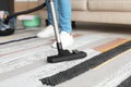 Man hoovering carpet with vacuum cleaner