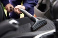 Man Hoovering Seat Of Car During Car Cleaning Royalty Free Stock Photo