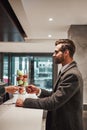 Man in Hotel check in at reception or front office being given key card Royalty Free Stock Photo